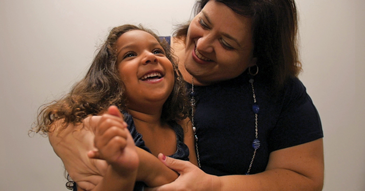 mom hugs her toddler