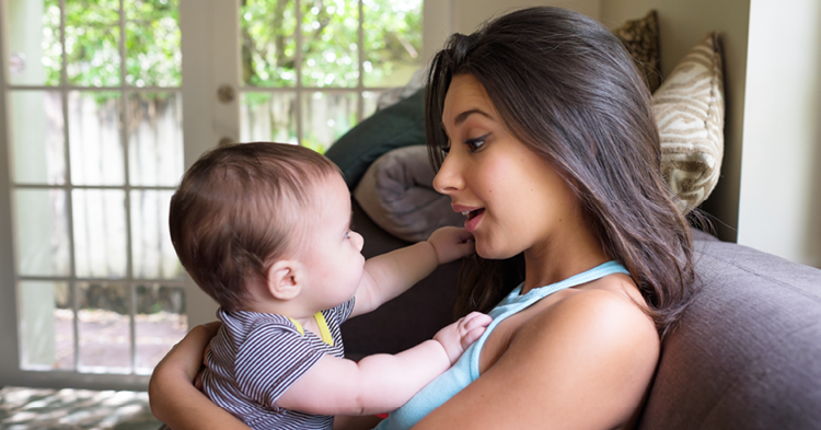 Latina mother talking with her baby