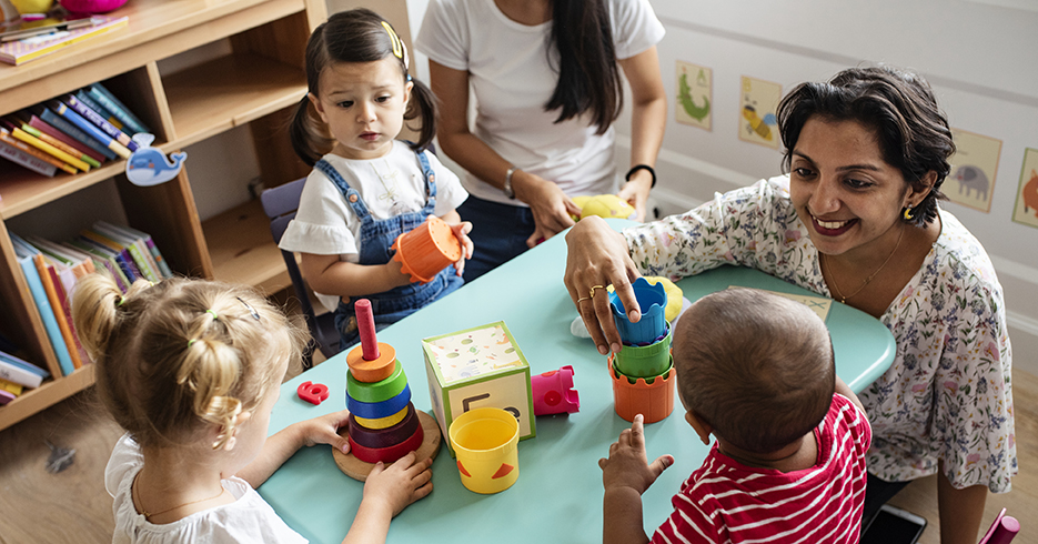 child care teacher with children in child care center